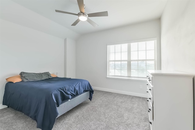 bedroom with ceiling fan, baseboards, lofted ceiling, and carpet