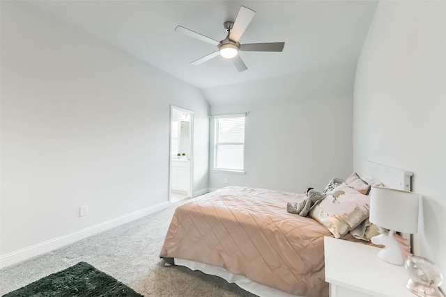 bedroom featuring vaulted ceiling, baseboards, a ceiling fan, ensuite bath, and carpet floors