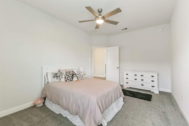 carpeted bedroom with visible vents, baseboards, and ceiling fan