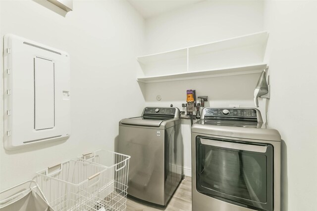 20002 Roan Ardennes Ln, Tomball, TX 77377 - clothes washing area with washer and clothes dryer and light wood-style floors