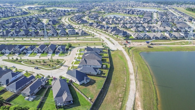 drone / aerial view featuring a residential view and a water view
