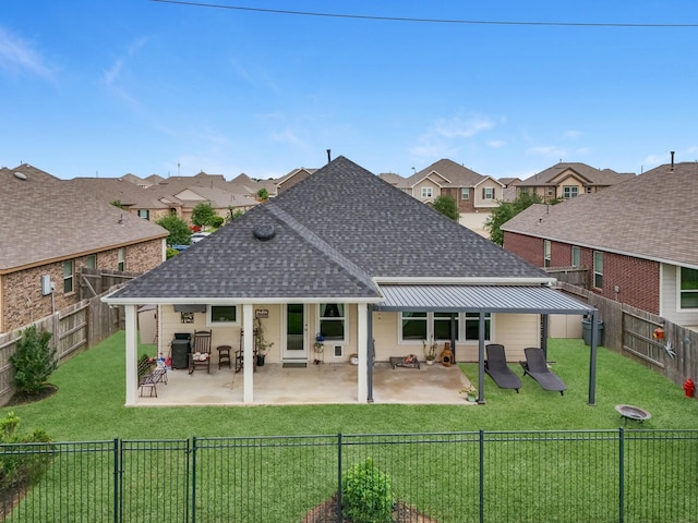 back of property with a residential view, a lawn, a shingled roof, and a fenced backyard