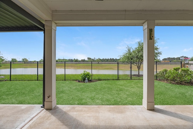 view of yard with a fenced backyard, a water view, and a patio