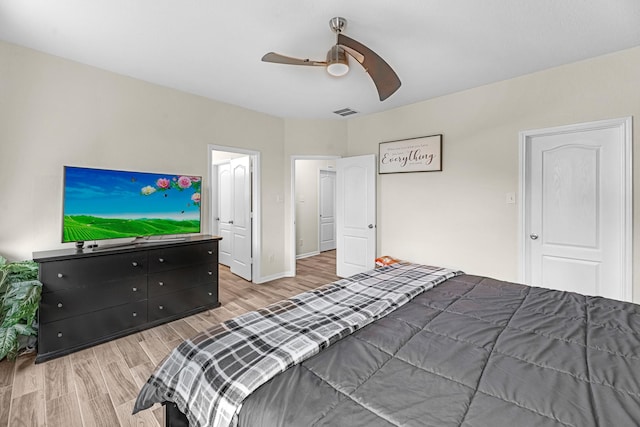 bedroom featuring ceiling fan, baseboards, visible vents, and light wood-style flooring
