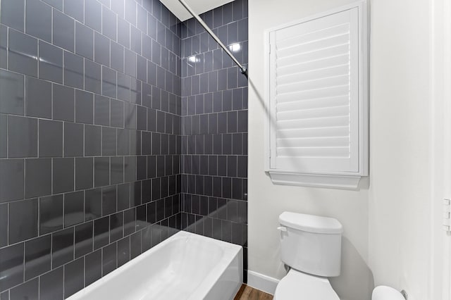 bathroom featuring shower / bath combination and toilet