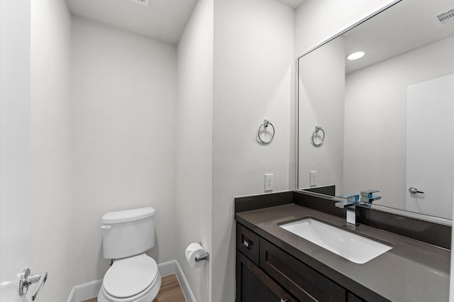 312 Eado Park Cir, Houston, TX 77020 - bathroom featuring toilet, vanity, baseboards, and wood finished floors