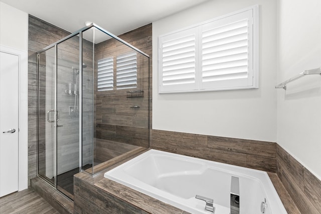 full bathroom featuring a shower stall and a bath