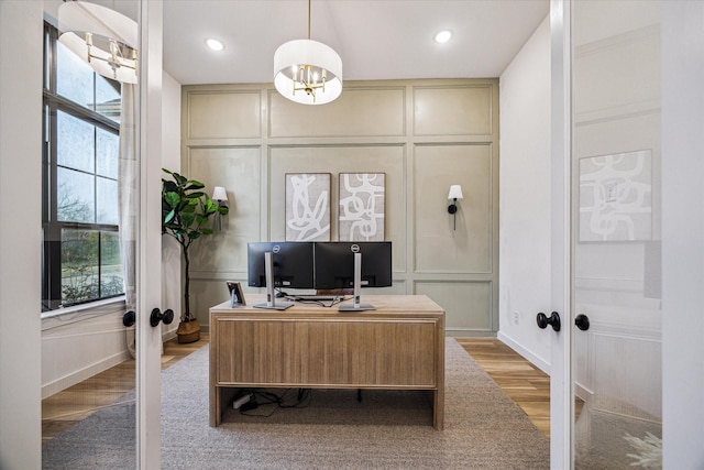 8818 Laurel Crest Dr, Missouri City, TX 77459 - office featuring light wood-type flooring, french doors, a chandelier, and a decorative wall