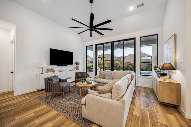 8818 Laurel Crest Dr, Missouri City, TX 77459 - living room with vaulted ceiling, visible vents, light wood-style floors, and a ceiling fan