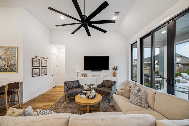 8818 Laurel Crest Dr, Missouri City, TX 77459 - living area featuring vaulted ceiling, wood finished floors, visible vents, a ceiling fan, and baseboards