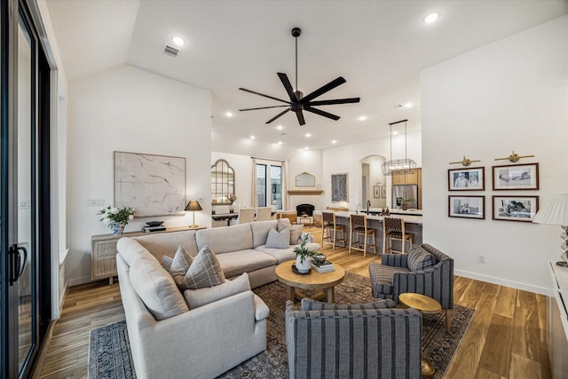 8818 Laurel Crest Dr, Missouri City, TX 77459 - living area featuring recessed lighting, light wood finished floors, visible vents, arched walkways, and ceiling fan