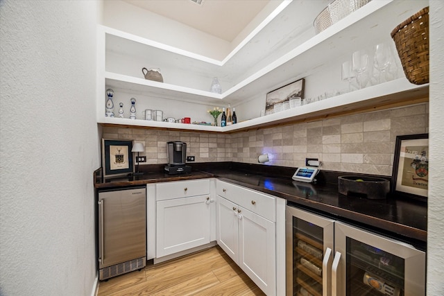 8818 Laurel Crest Dr, Missouri City, TX 77459 - bar featuring tasteful backsplash, bar area, light wood finished floors, and wine cooler