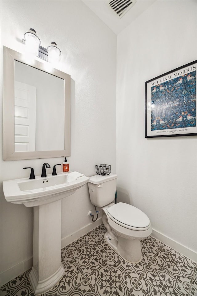 8818 Laurel Crest Dr, Missouri City, TX 77459 - half bathroom featuring a sink, toilet, baseboards, visible vents, and tile patterned flooring