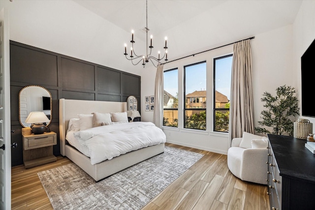 8818 Laurel Crest Dr, Missouri City, TX 77459 - bedroom with a chandelier, light wood-style floors, and vaulted ceiling