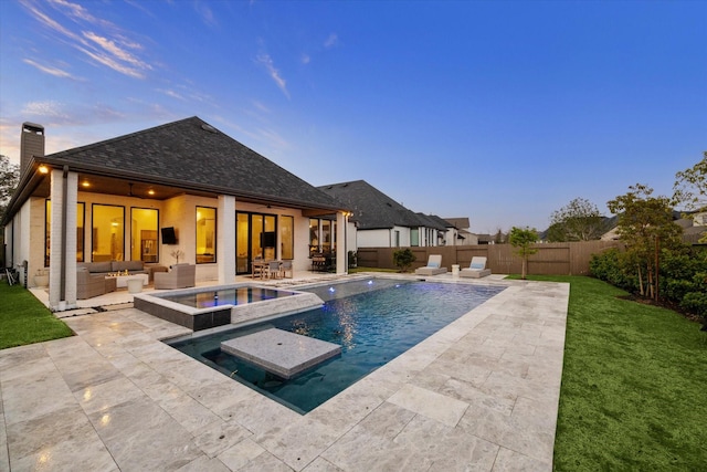 8818 Laurel Crest Dr, Missouri City, TX 77459 - pool at dusk featuring a patio area, a lawn, outdoor lounge area, a fenced backyard, and ceiling fan
