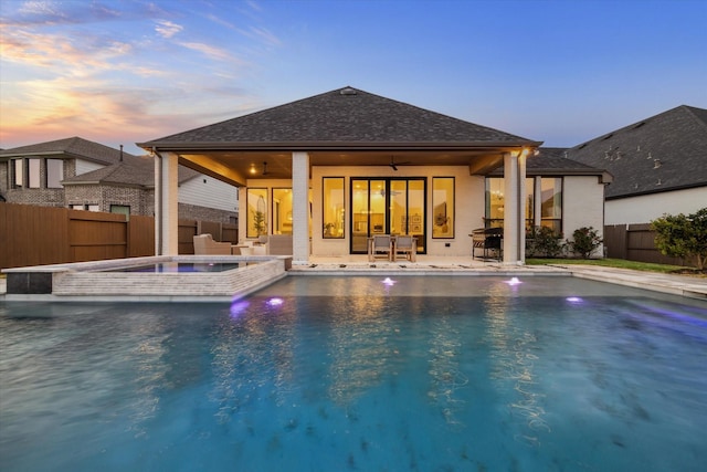 8818 Laurel Crest Dr, Missouri City, TX 77459 - back of house with a fenced backyard, a patio area, a shingled roof, ceiling fan, and a pool with connected hot tub