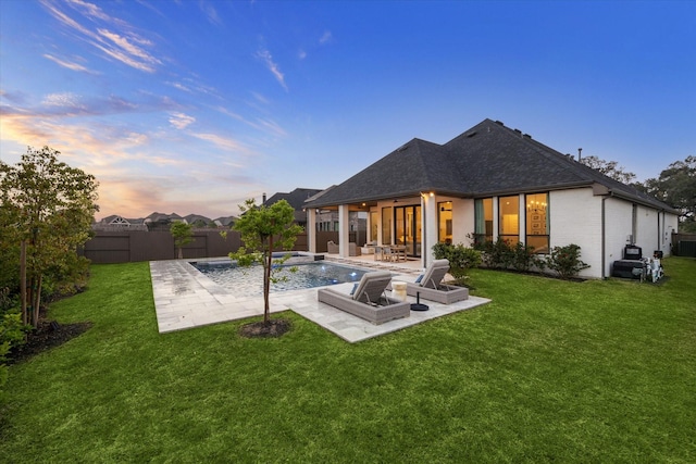 8818 Laurel Crest Dr, Missouri City, TX 77459 - back of property at dusk with a fenced in pool, a fenced backyard, a yard, a patio area, and roof with shingles