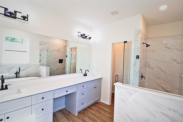 24994 Armagh St, Hempstead, TX 77445 - full bath featuring a marble finish shower, double vanity, and wood finished floors