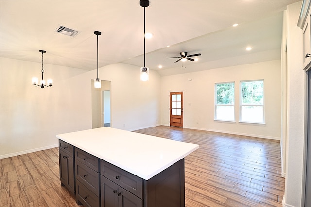 24994 Armagh St, Hempstead, TX 77445 - kitchen with light wood-style flooring, baseboards, a center island, light countertops, and decorative light fixtures