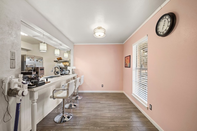 8931 Gaylord St Unit 161, Houston, TX 77024 - interior space with decorative light fixtures, dark wood-style flooring, crown molding, and a breakfast bar
