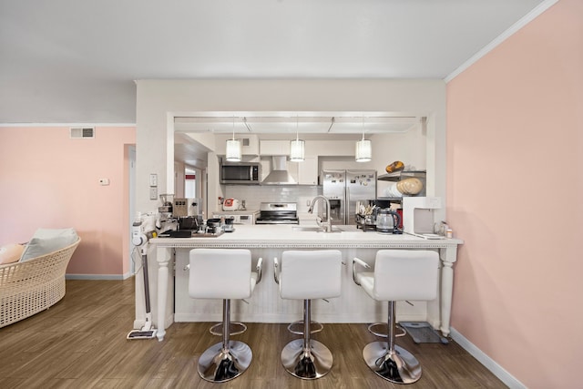 8931 Gaylord St Unit 161, Houston, TX 77024 - bar with stainless steel appliances, visible vents, a sink, wall chimney exhaust hood, and decorative backsplash