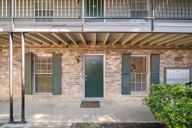 8931 Gaylord St Unit 161, Houston, TX 77024 - view of exterior entry with a balcony and brick siding