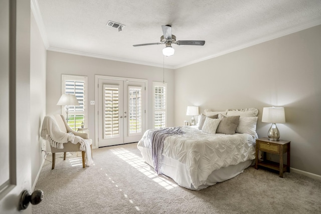 bedroom featuring access to outside, ornamental molding, french doors, and visible vents