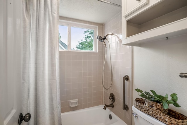 bathroom with shower / bath combo with shower curtain, toilet, and a textured ceiling