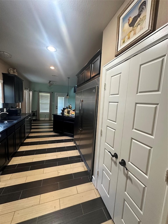 115 Shadow Springs Trl, Magnolia, TX 77354 - kitchen featuring built in refrigerator, dishwasher, a sink, dark countertops, and recessed lighting