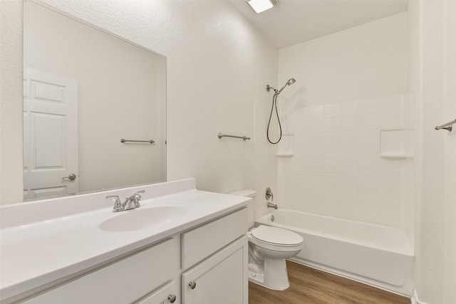 bathroom with toilet, vanity, wood finished floors, and bathing tub / shower combination