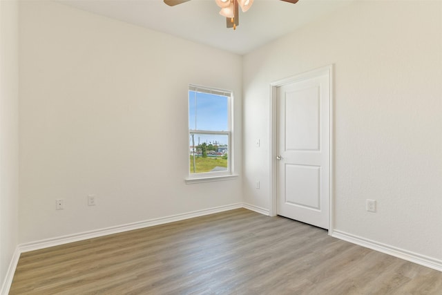 unfurnished room with baseboards, a ceiling fan, and wood finished floors