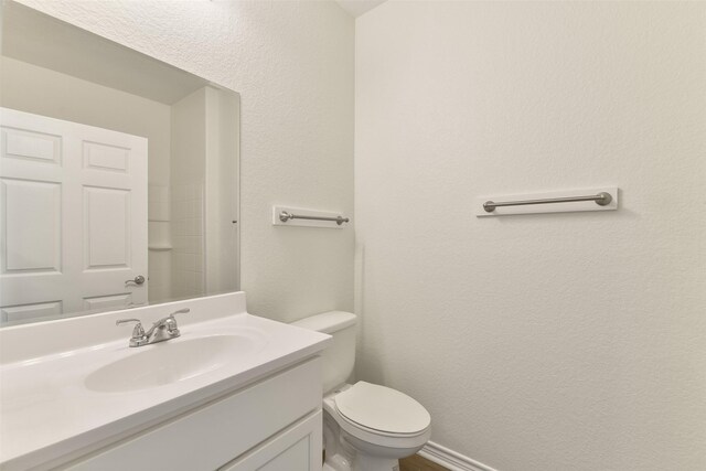 bathroom with toilet and vanity