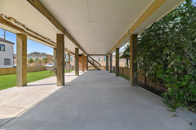 view of patio with stairway and fence
