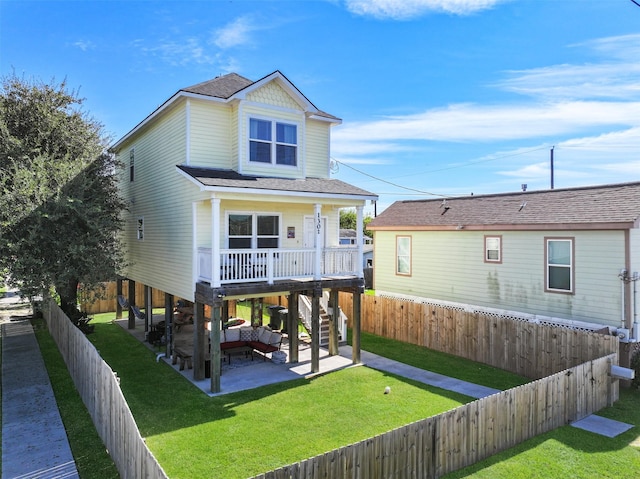 1302 55th St, Galveston, TX 77551 - back of house featuring a fenced backyard, a patio area, a shingled roof, stairway, and a yard