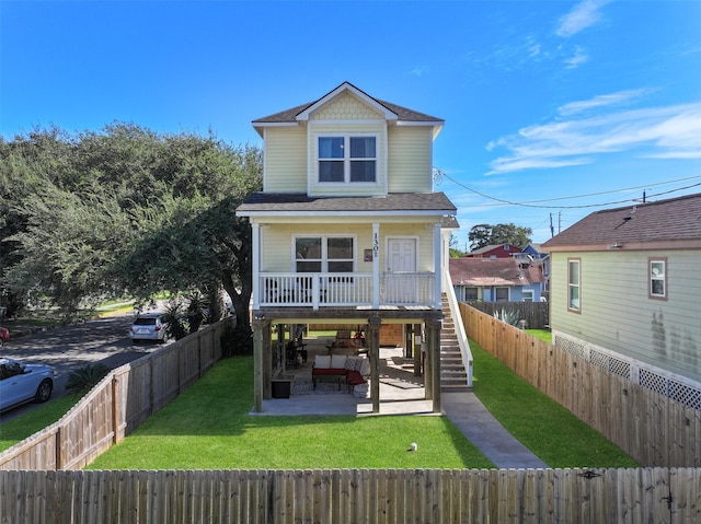 1302 55th St, Galveston, TX 77551 - rear view of house featuring stairway, a fenced backyard, a yard, a patio, and roof with shingles