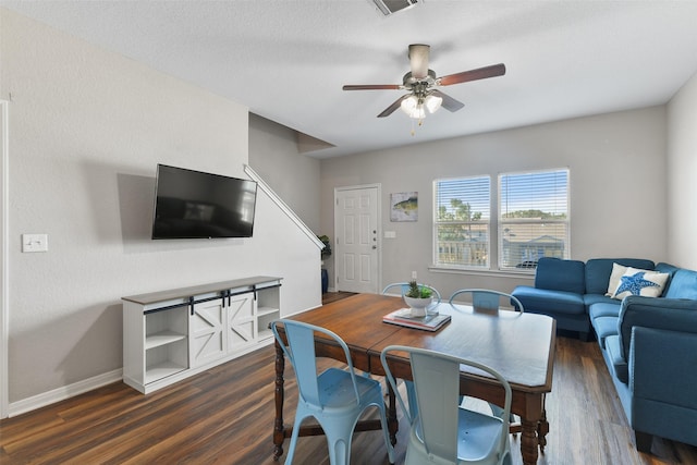 1302 55th St, Galveston, TX 77551 - dining room featuring stairway, dark wood-style floors, ceiling fan, baseboards, and visible vents