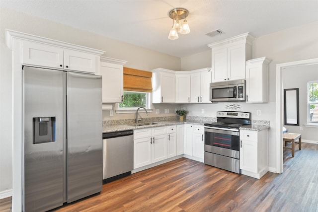 1302 55th St, Galveston, TX 77551 - kitchen featuring stainless steel appliances, visible vents, a sink, and plenty of natural light