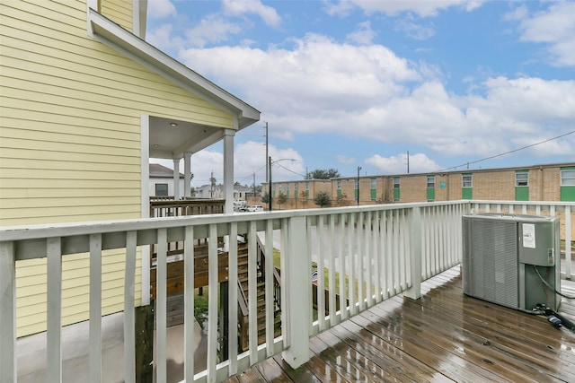 view of wooden balcony featuring central AC and a deck