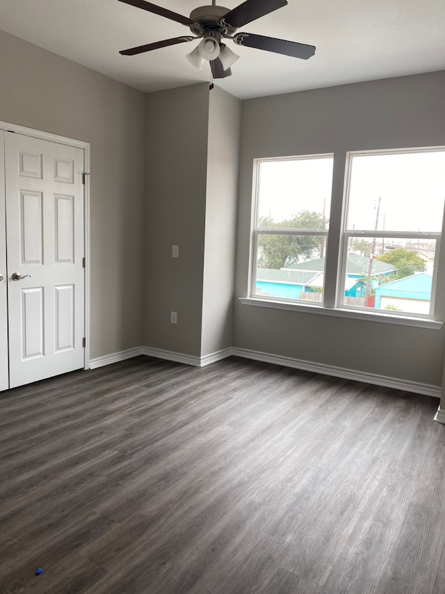 5423 Avenue N 1/2 Ave N Unit 1/2, Galveston, TX 77551 - unfurnished room with dark wood finished floors, baseboards, and ceiling fan