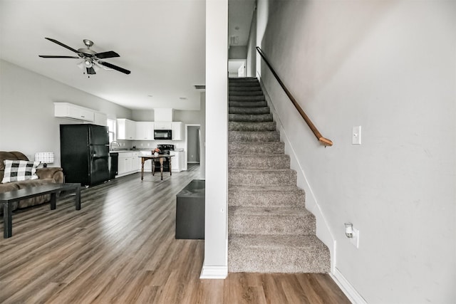 2811 Winnie St, Galveston, TX 77550 - stairway featuring wood finished floors, a ceiling fan, and baseboards