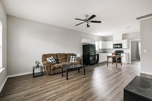 2811 Winnie St, Galveston, TX 77550 - living room with wood finished floors, visible vents, baseboards, and ceiling fan