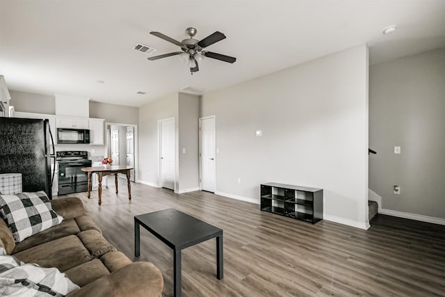 2811 Winnie St, Galveston, TX 77550 - living room featuring wood finished floors, visible vents, a ceiling fan, and baseboards