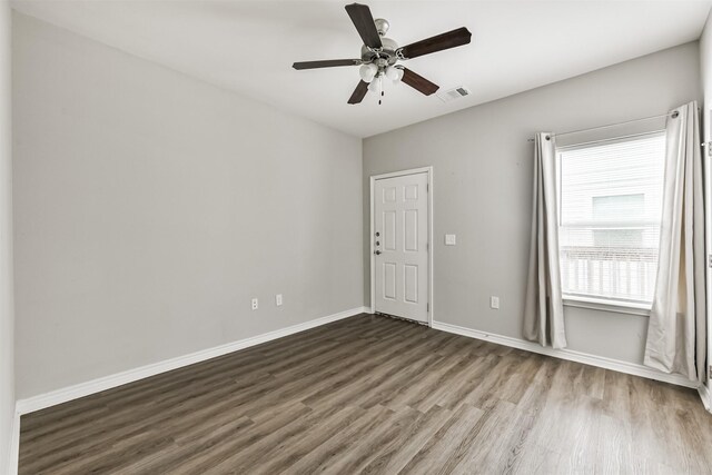 2811 Winnie St, Galveston, TX 77550 - empty room featuring baseboards, wood finished floors, visible vents, and ceiling fan