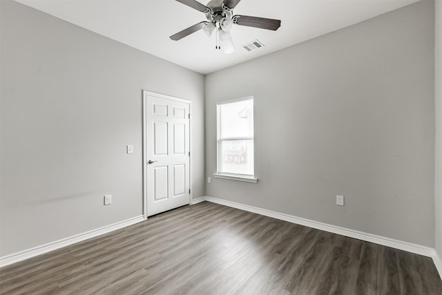 2811 Winnie St, Galveston, TX 77550 - spare room featuring dark wood-type flooring, visible vents, baseboards, and ceiling fan