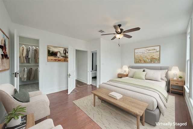 spare room with plenty of natural light, baseboards, ceiling fan, and wood-type flooring