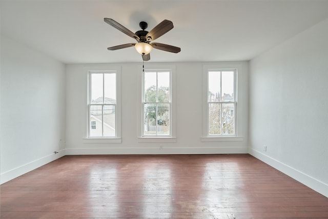 1323 Ball, Galveston, TX 77550 - unfurnished room featuring healthy amount of natural light, hardwood / wood-style flooring, baseboards, and a ceiling fan