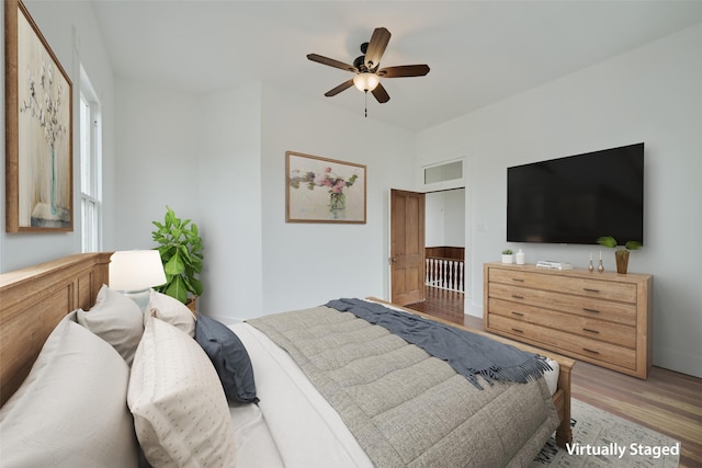 unfurnished room featuring baseboards, a ceiling fan, and dark wood-style floors