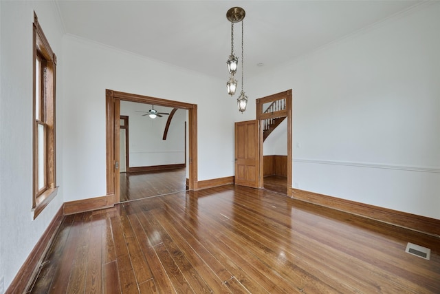 1323 Ball, Galveston, TX 77550 - unfurnished dining area with crown molding, hardwood / wood-style flooring, baseboards, a ceiling fan, and stairway