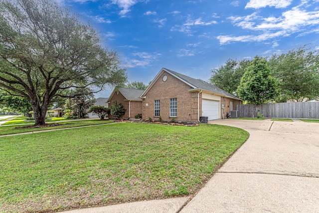 6249 Mallard Dr, Katy, TX 77493 - view of side of home with concrete driveway, an attached garage, fence, a yard, and brick siding