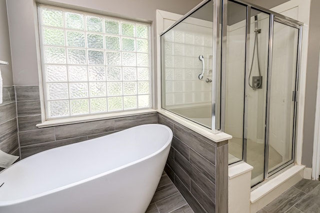 6249 Mallard Dr, Katy, TX 77493 - full bathroom with a shower stall, tile walls, and plenty of natural light